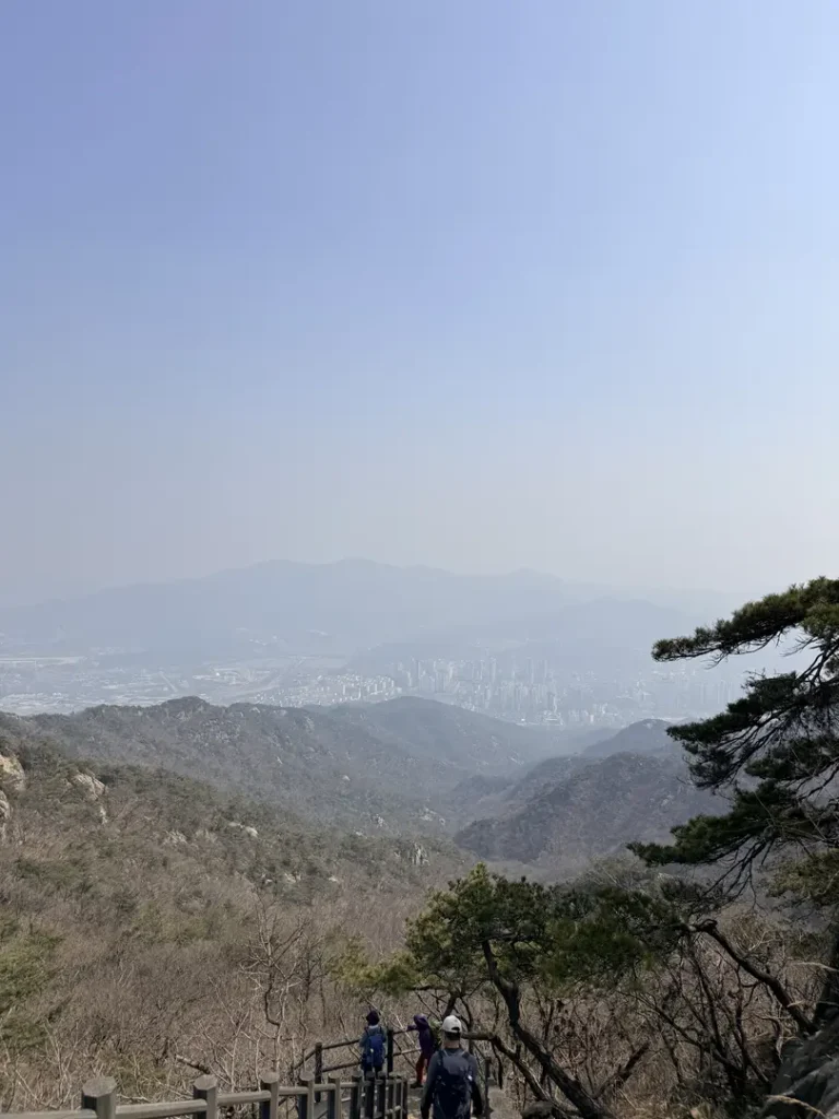 Hikers viewing Seoul cityscape from Gwanaksan mountain overlook