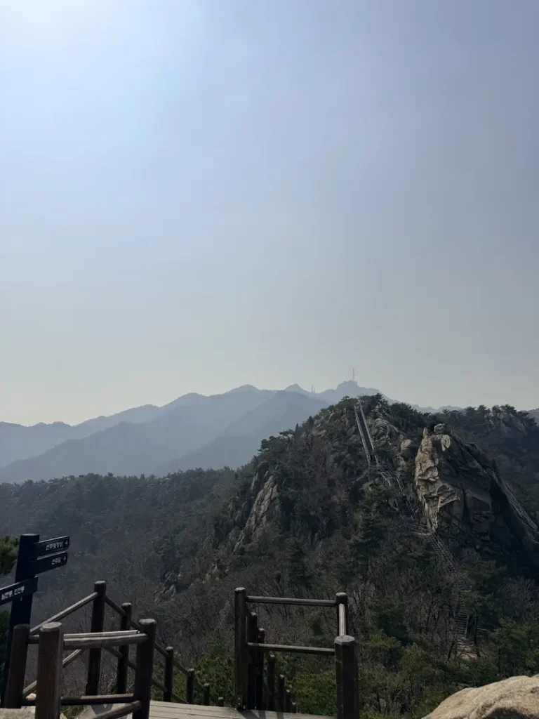 Rocky mountain peak with metal chain bridge on Gwanaksan hiking trail