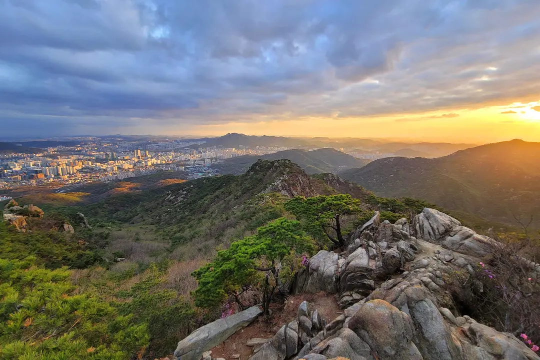 Gwanaksan summit overlooks Seoul cityscape at golden sunset