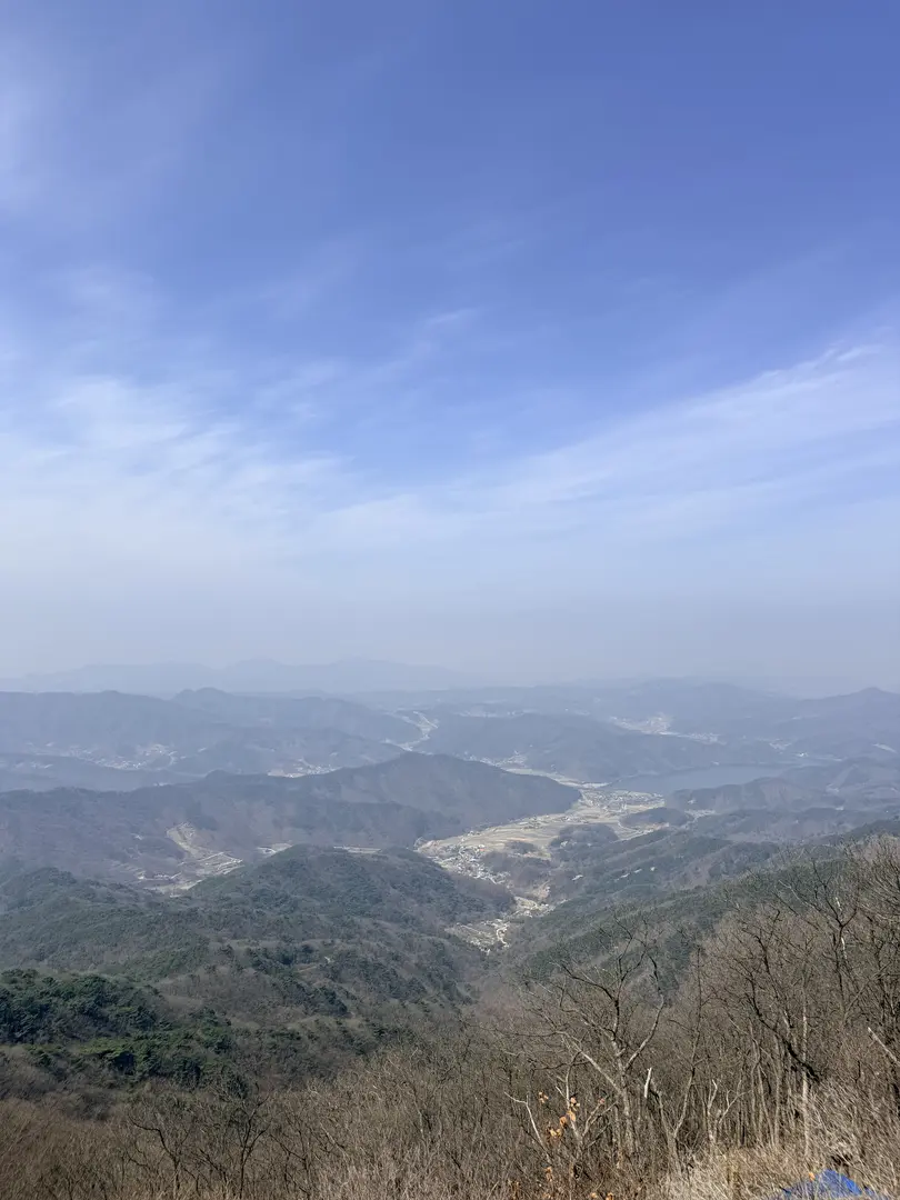 Expansive mountain valley landscape from Gwangdeoksan summit ridge