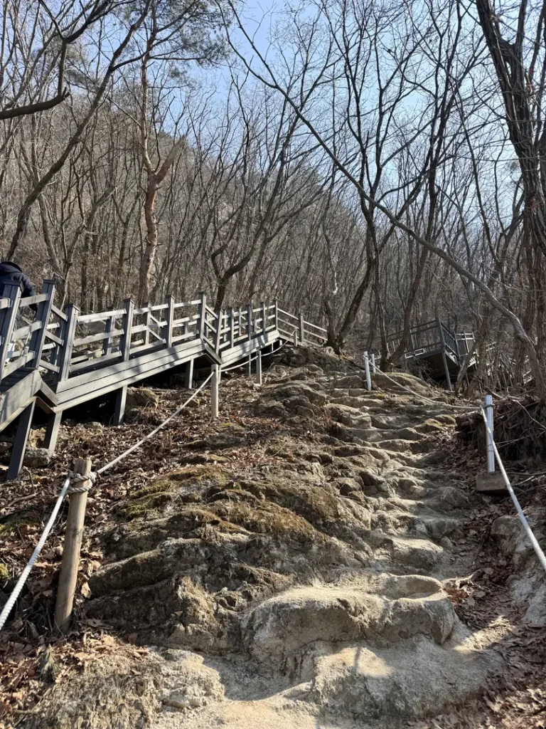 Wooden boardwalk and stone steps on Hoamsan Mountain hiking trail
