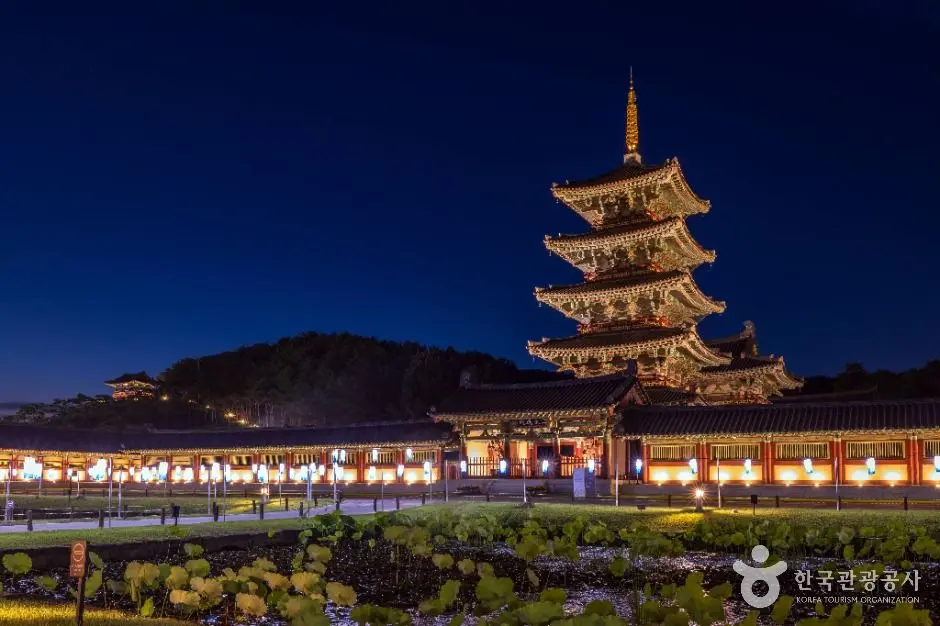 Illuminated traditional Korean pagoda at Baekje Cultural Complex at dusk