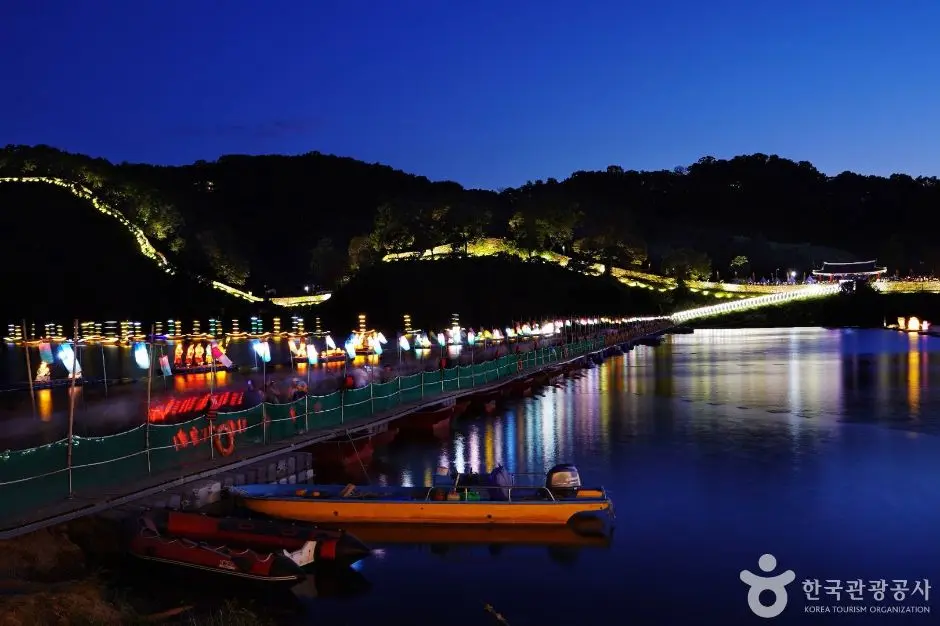 Baekje Cultural Festival illuminated riverside venue at night with lanterns and boat