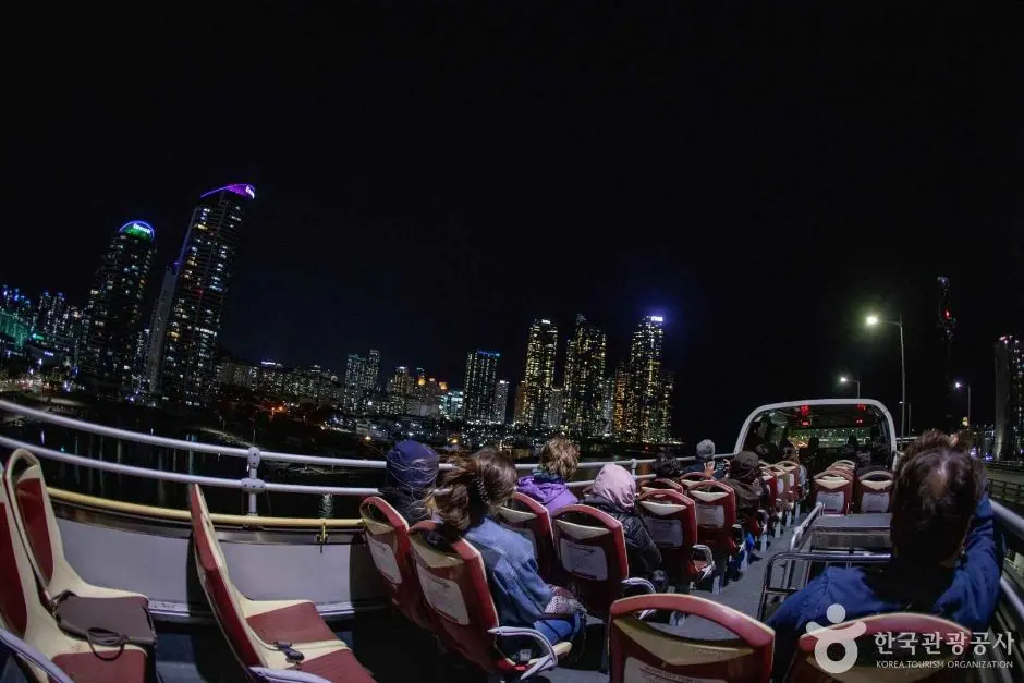 Busan city tour open-top bus at night with skyline view