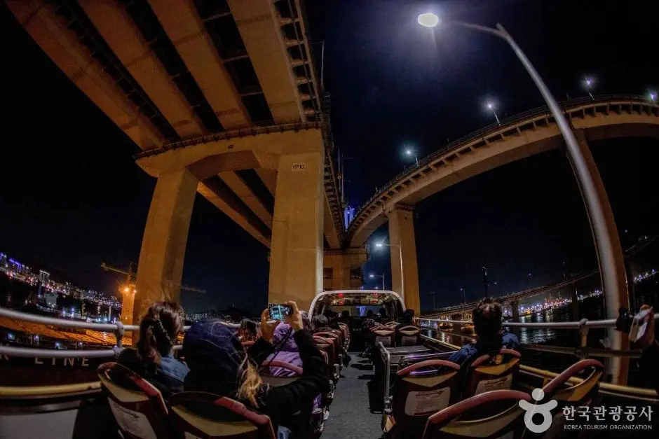 Busan city tour bus passengers on elevated highway at night