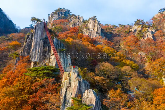 Daedunsan mountain landscape with golden autumn foliage and dramatic rock formations