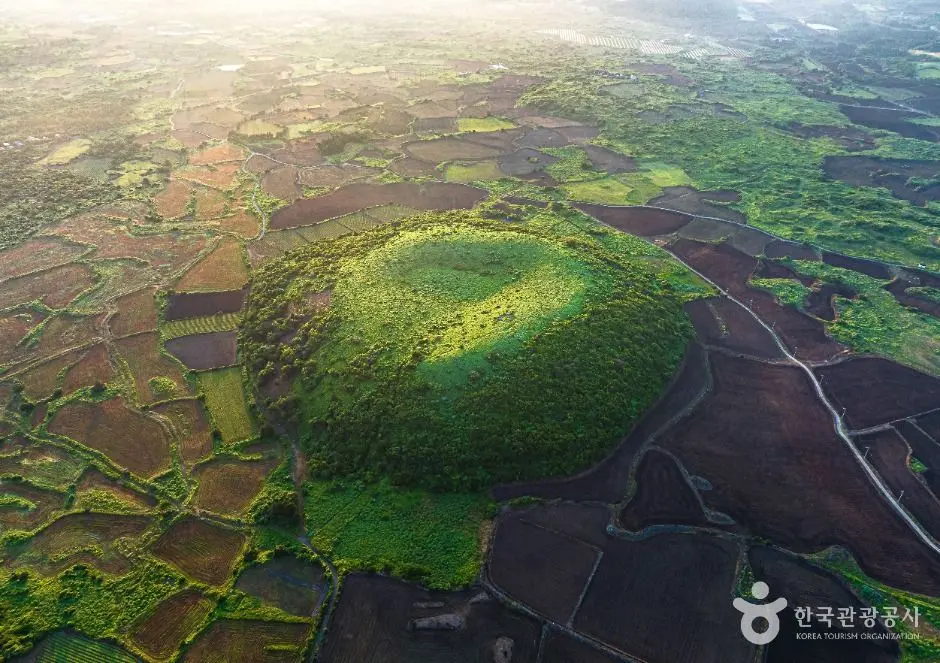 Aerial morning view of Darangshi Oreum crater surrounded by agricultural fields
