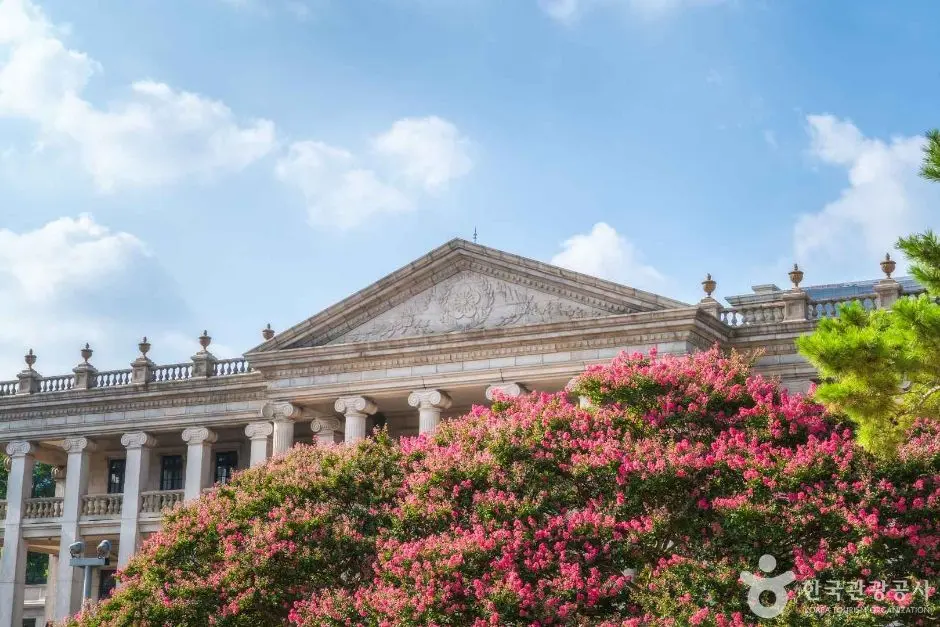 Deoksugung Palace western architecture with pink flowering shrubs