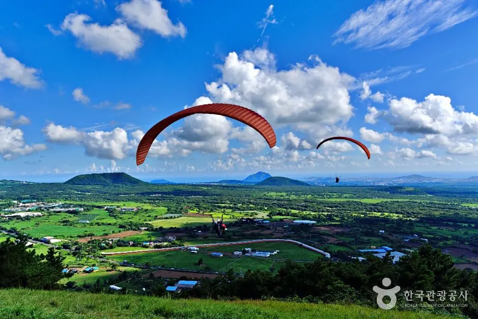 Paragliders soaring above Geum Oreum