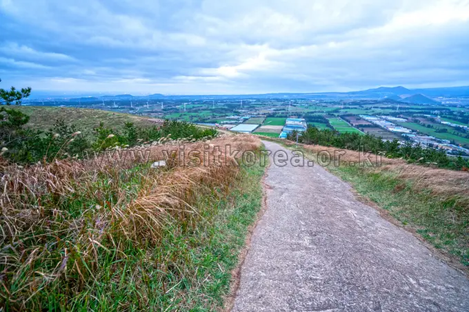 Summit trail panorama at Geum Oreum Jeju with expansive valley views