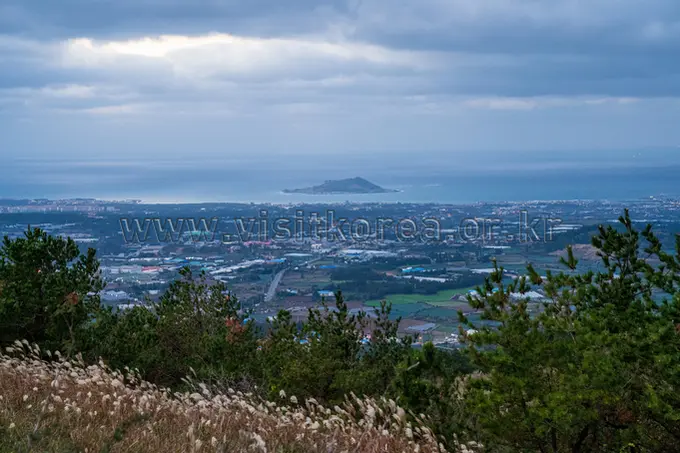 Panoramic vista from Geum Oreum summit overlooking Jeju island landscape