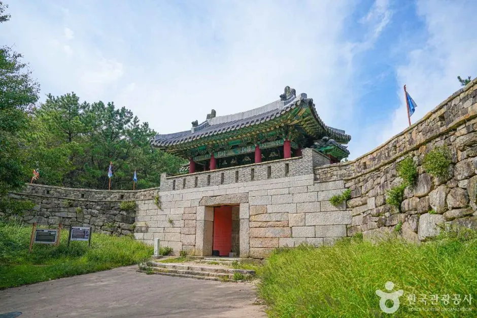 Traditional Korean fortress gate at Geumjeongsan with curved tile roof and stone walls