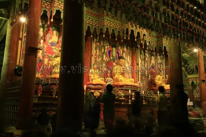 Golden Buddha statue and ornate decorations inside Haeinsa Temple