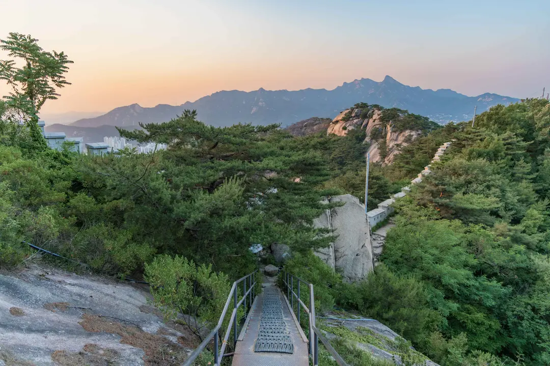Inwangsan hiking trail pathway with Seoul mountains at sunset
