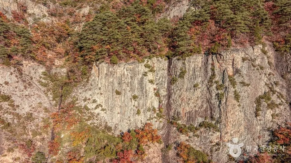 Columnar basalt rock formations at Juwangsan National Park with moss and lichen
