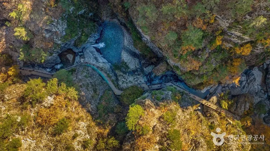 Aerial view of winding river through forested Juwangsan valley