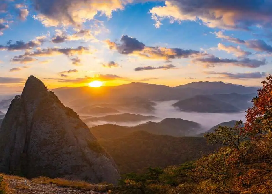 Maisan Mountain sunrise with golden light over misty valleys and peaks
