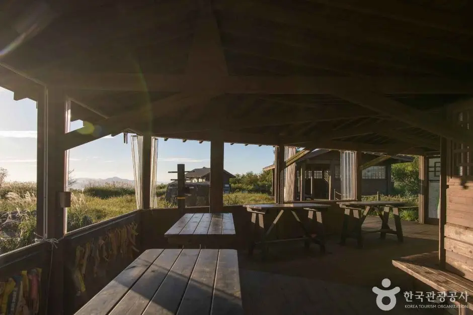 Covered wooden pavilion shelter overlooking Mudeungsan National Park landscape and mountains