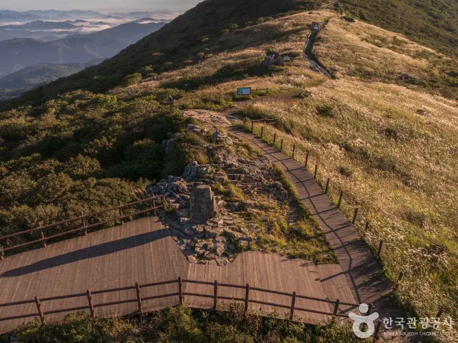 Wooden boardwalk trail winding through Mudeungsan mountain landscape