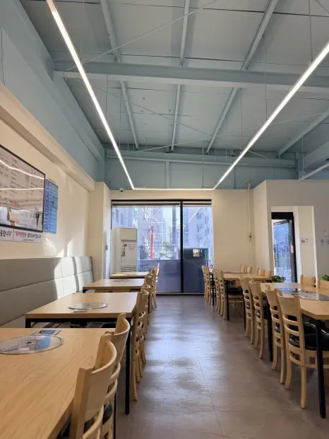 Empty restaurant dining room with wooden tables and chairs