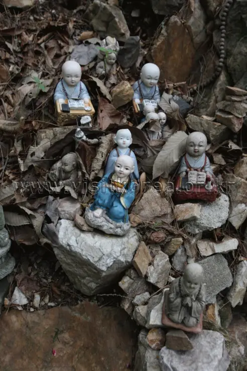 Stone Buddha statues and figurines on Soyosan Mountain hiking trail