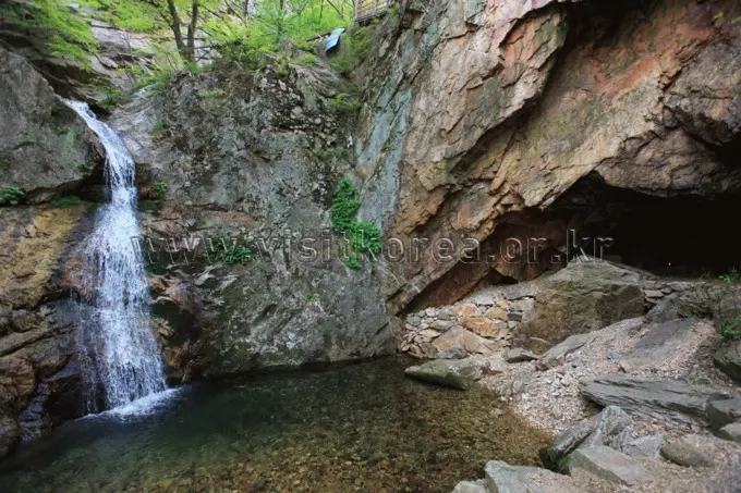 Small waterfall cascading into clear pool at Soyosan Mountain base