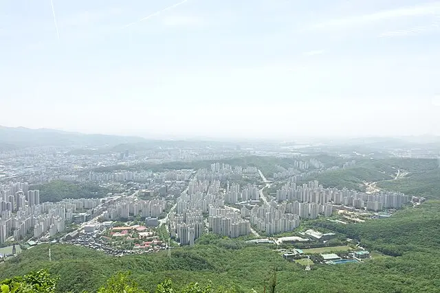 Panoramic view from Surisan summit overlooking sprawling city and green valleys
