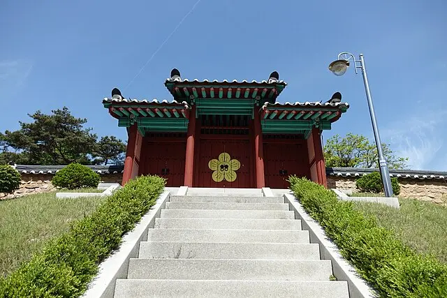 Red and green traditional Korean temple pavilion with golden ornament at Surisan