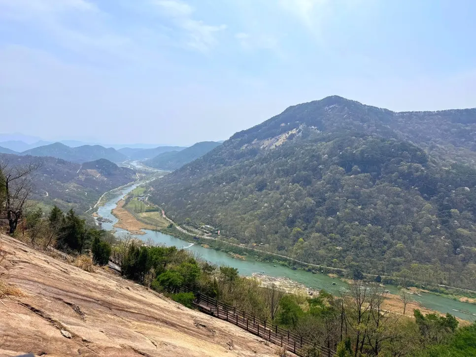 Turquoise Seomjingang River winding through forested valley and mountains