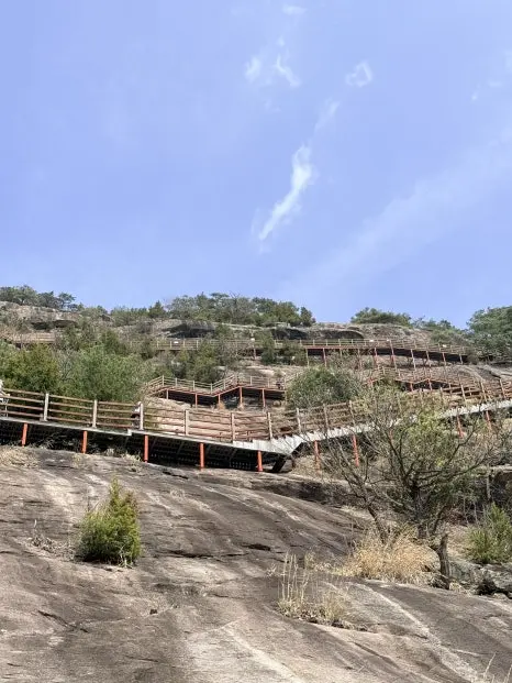Wooden boardwalk structures built into hillside along Yonggwolsan Sky Trail
